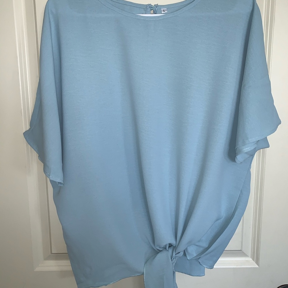 Light blue blouse with tie at bottom